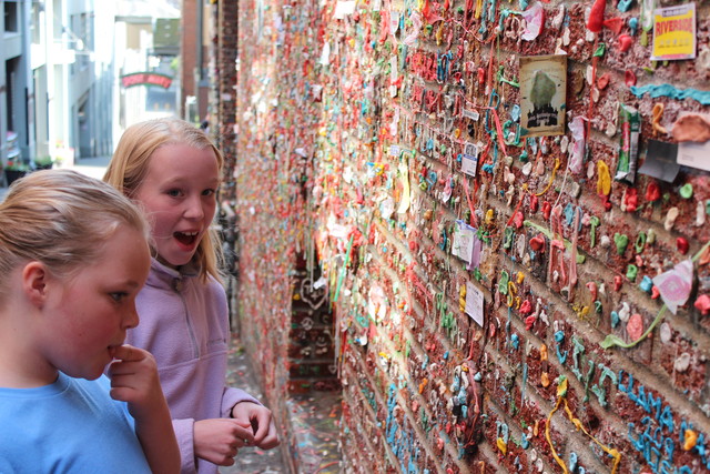Sarah and Emma adding their offering to the gum wall in Seattle