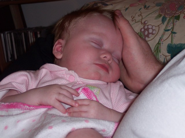 Emma asleep on Dad's hand