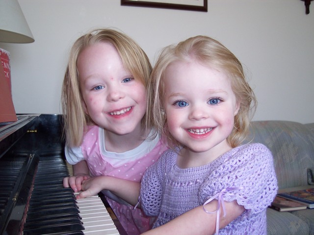 Emma and Sarah playing the piano