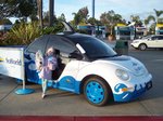 Emma with her dolphin and (free!!) cotton candy standing in front of the Shamu car at Sea World