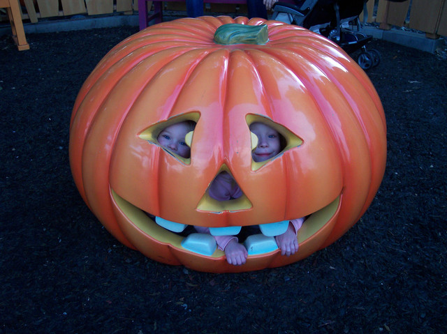 Sarah and Emma swallowed by a pumpkin in Goofy's yard at Disneyland