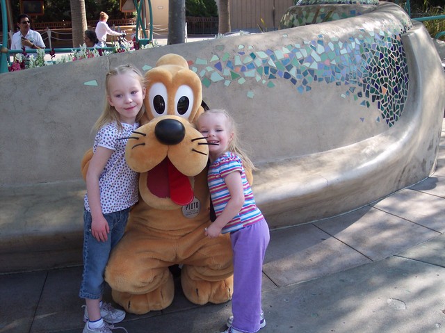 Sarah and Emma with Pluto at Disneyland