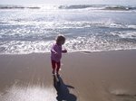 Sarah running away from a wave at Huntington Beach