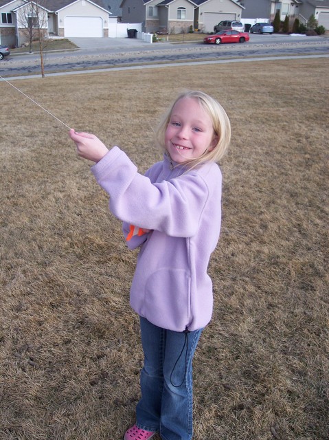 Emma flying a kite in the park