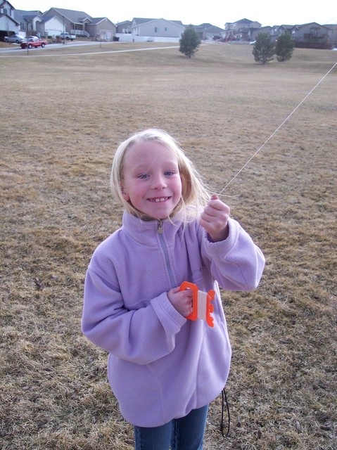 Emma flying a kite in the park