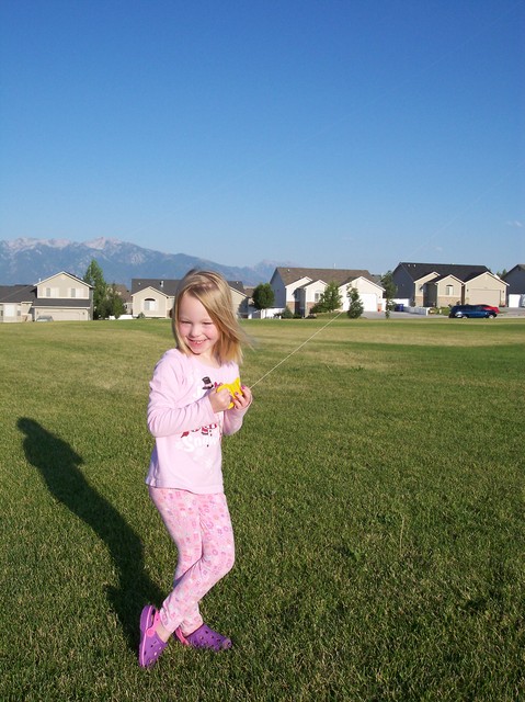Emma flying kite at park