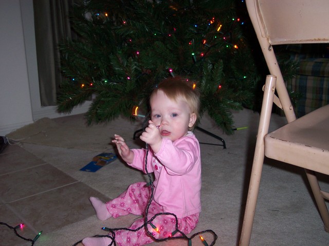 Emma playing with Christmas lights