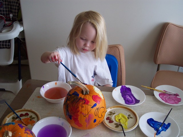 Emma decorating pumpkins