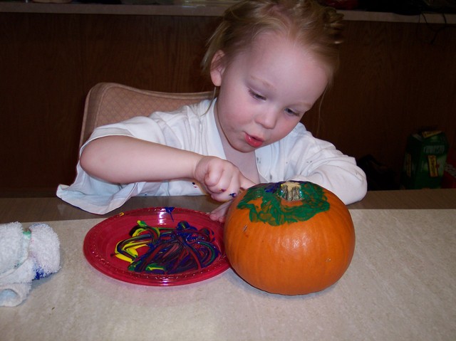 Emma painting pumpkins