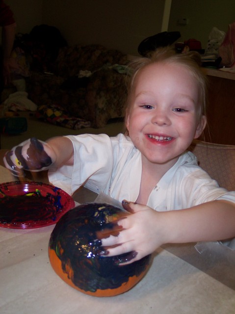 Emma painting pumpkins