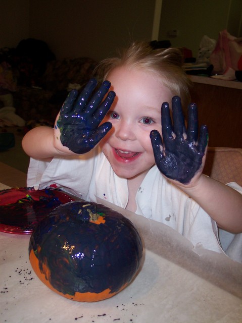 Emma painting pumpkins