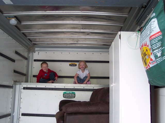 Nathan and Emma playing in the back of a U-Haul