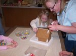 Camille and Emma building a gingerbread house on Emma's 6th Birthday