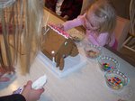 Sarah building a gingerbread house on Emma's 6th Birthday