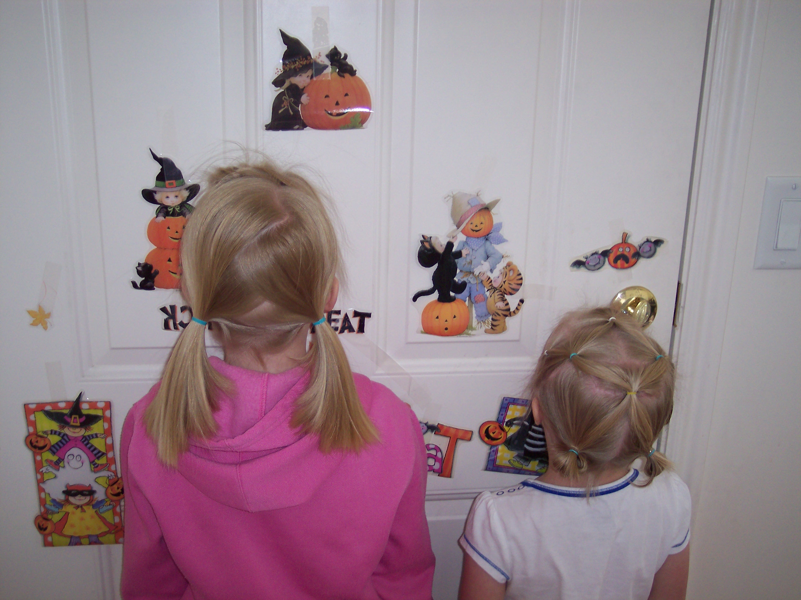 Emma and Sarah showing off their hair and halloween decorations