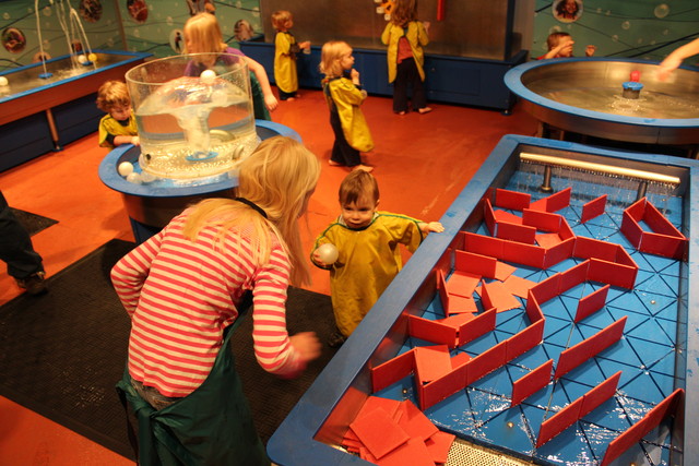 Emma helping a little boy at the OMSI